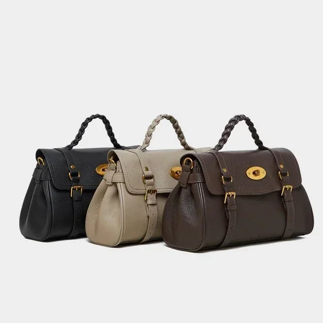 Three leather handbags in black, taupe, and brown with gold hardware on a white background.