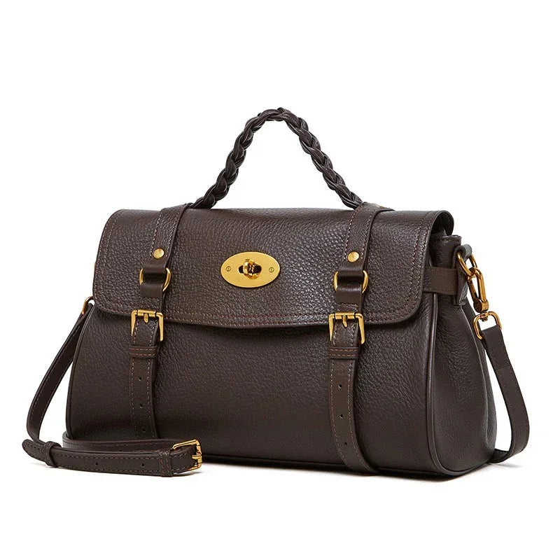 Dark brown leather handbag with gold buckles and braided top handle