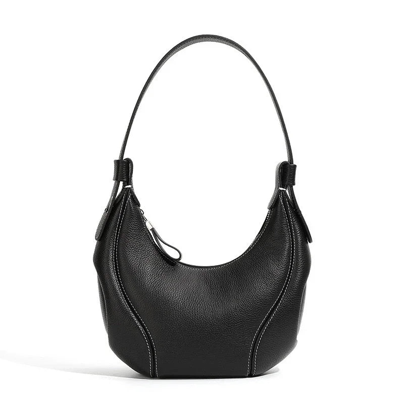 Black leather shoulder bag with curved design and white stitching on white background
