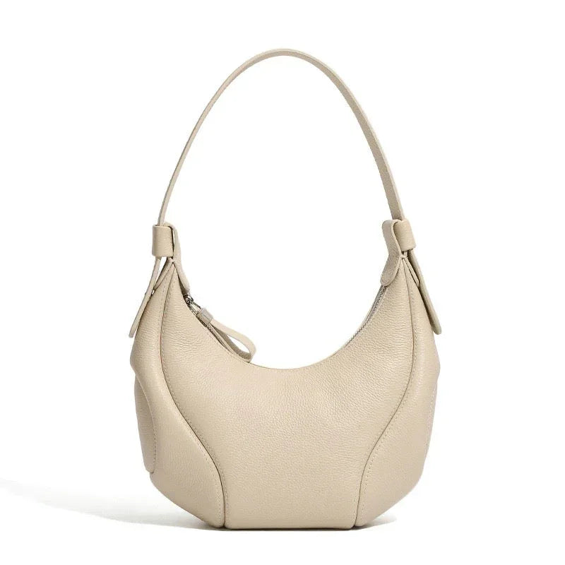 Beige leather hobo shoulder bag with zipper, minimalist design, on white background