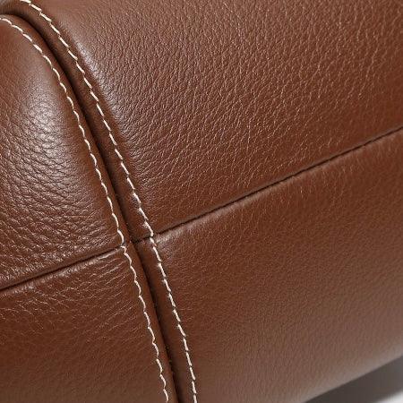 Close-up of brown leather upholstery with visible stitching detail