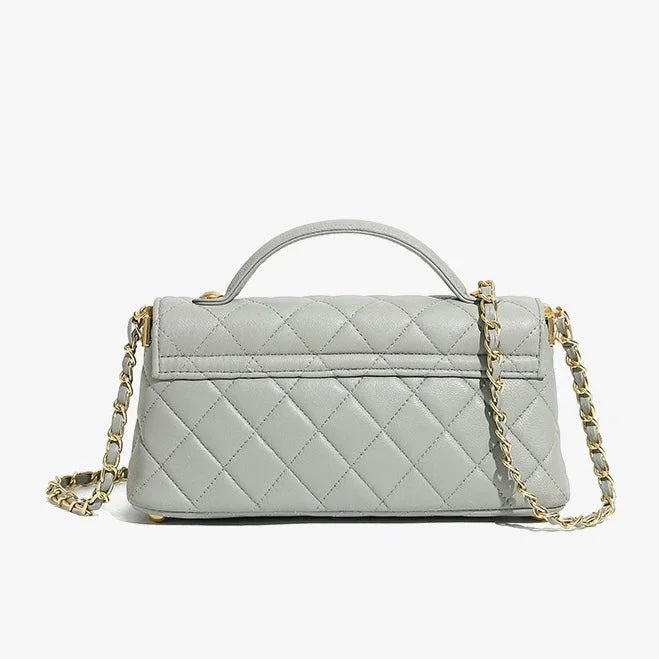 Quilted light gray leather handbag with gold chain strap on white background
