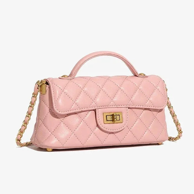 Quilted pink leather handbag with gold chain strap and turn-lock clasp on a white background