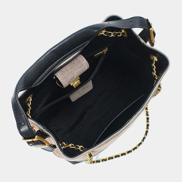 Open beige and black leather handbag with gold chain strap, inner pocket and clasp