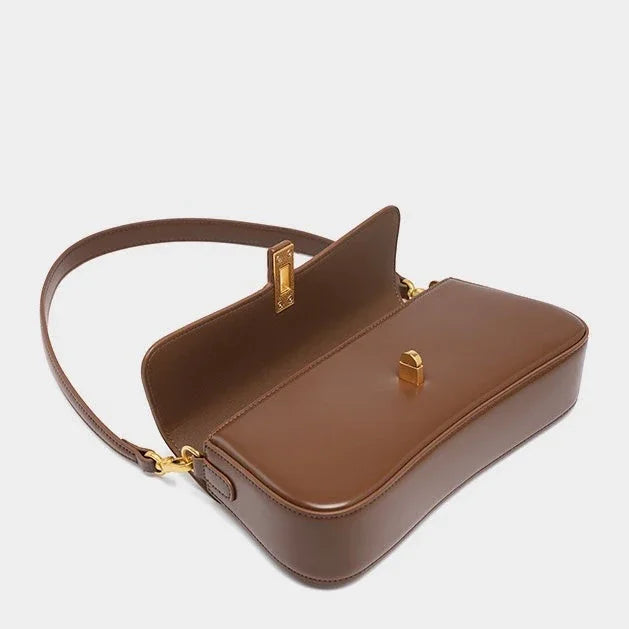 Brown leather shoulder bag with gold hardware on a white background