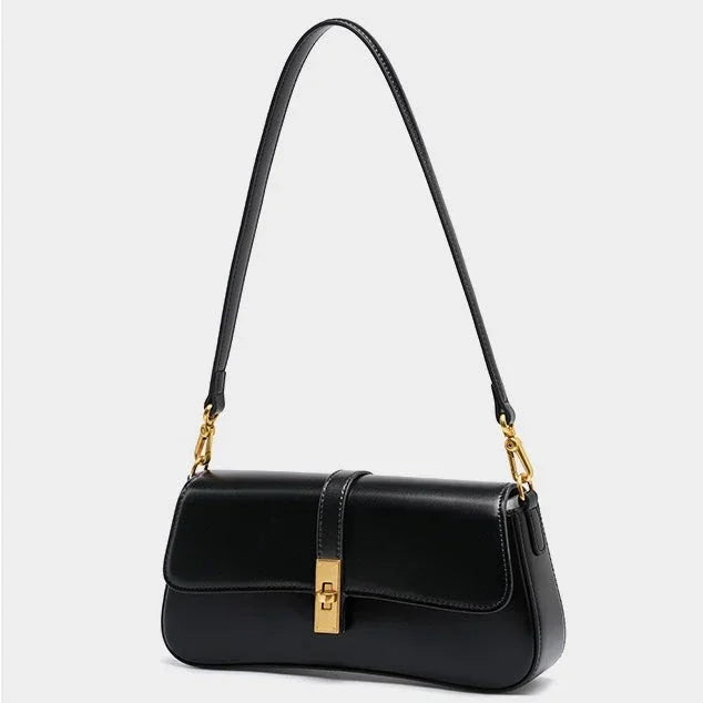 Black leather shoulder bag with gold hardware on a white background