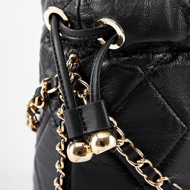 Quilted black leather bag with gold chain strap and drawstring closure detail