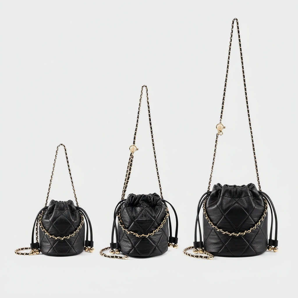 Three black quilted leather bucket bags with gold chain straps on white background