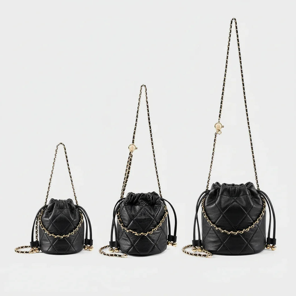 Three black quilted leather bucket bags with gold chain straps on white background
