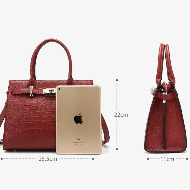 Red crocodile-texture handbag with gold hardware, dimensions 28.5x22x11cm, iPad for scale