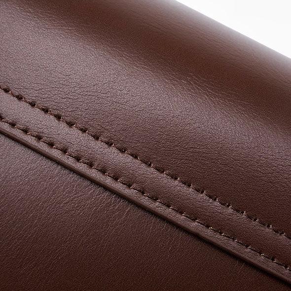 Close-up of brown leather with stitching, premium leather texture detail