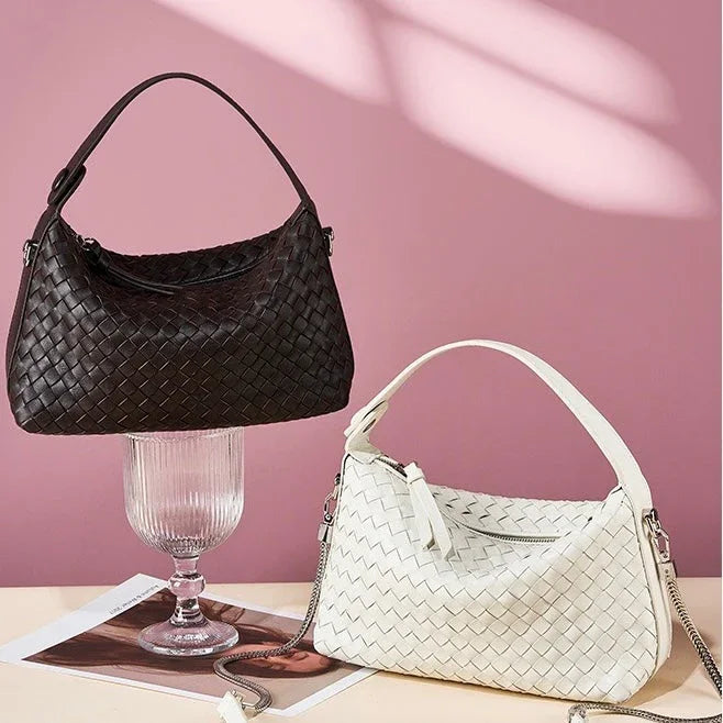 Black and white woven handbags displayed on a pink background with soft lighting