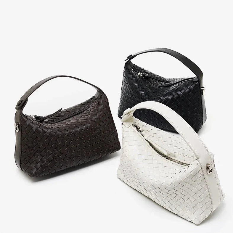Three woven leather handbags in black, brown, and white on a white background
