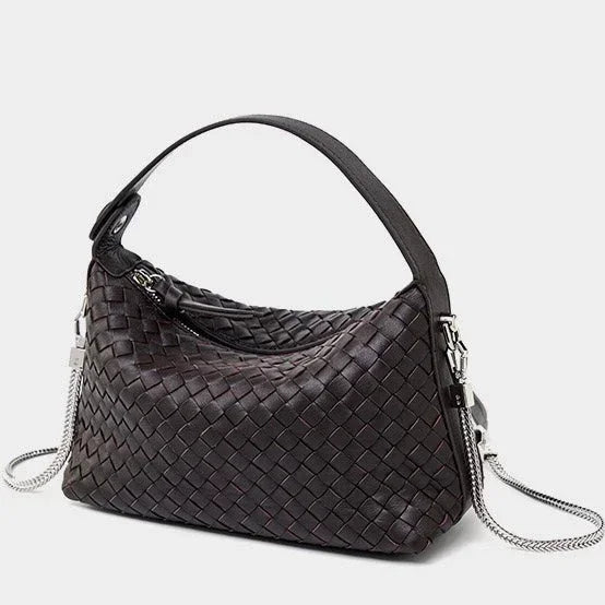 Dark brown woven leather handbag with top handle and silver chain strap on white background
