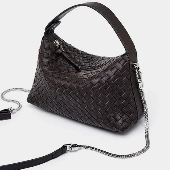 Dark brown woven leather handbag with silver chain strap on white background