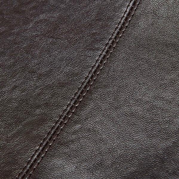 Close-up of dark brown leather upholstery with visible stitching seam