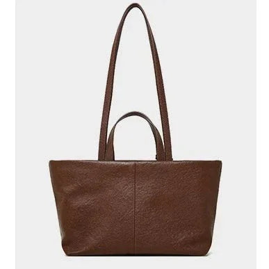 Brown leather tote bag with dual handles on a plain white background