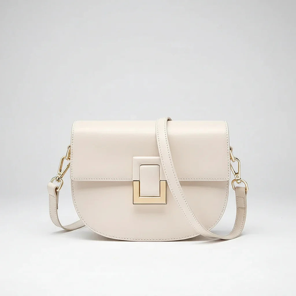 Cream leather crossbody bag with gold hardware and front square buckle detail
