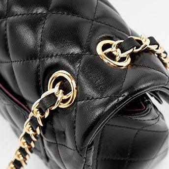 Black quilted leather handbag with gold chain strap and hardware