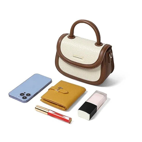 Small brown and cream handbag with smartphone, yellow wallet, lipstick, and makeup bottle