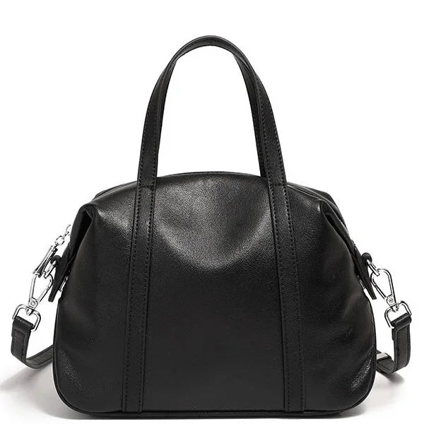 Black leather handbag with top handles and detachable shoulder strap on white background