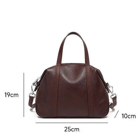 Brown leather handbag with shoulder strap, dimensions 25x19x10cm, on white background