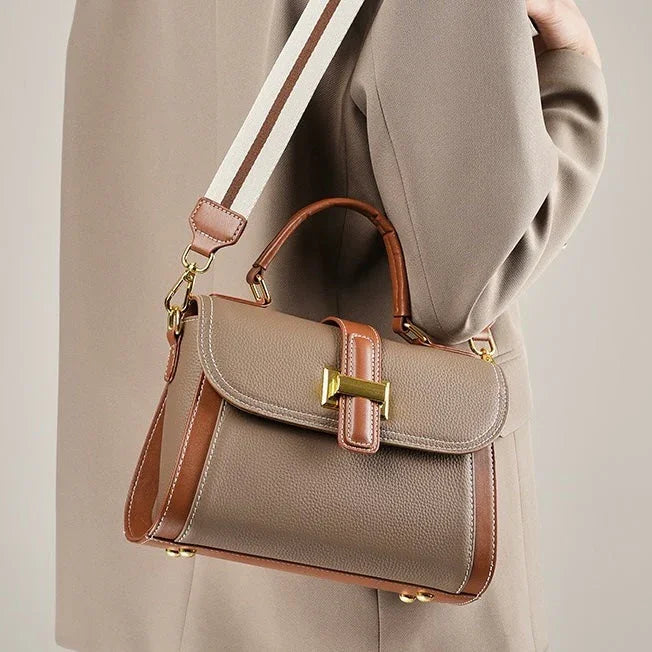 Taupe and brown leather handbag with gold buckle and striped shoulder strap