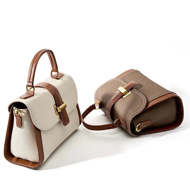Two leather handbags, beige and taupe with brown trim and gold hardware, on white background.
