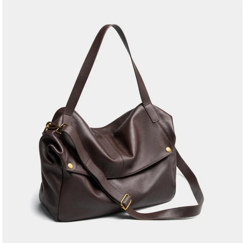 Brown leather shoulder bag with gold hardware on a plain light background