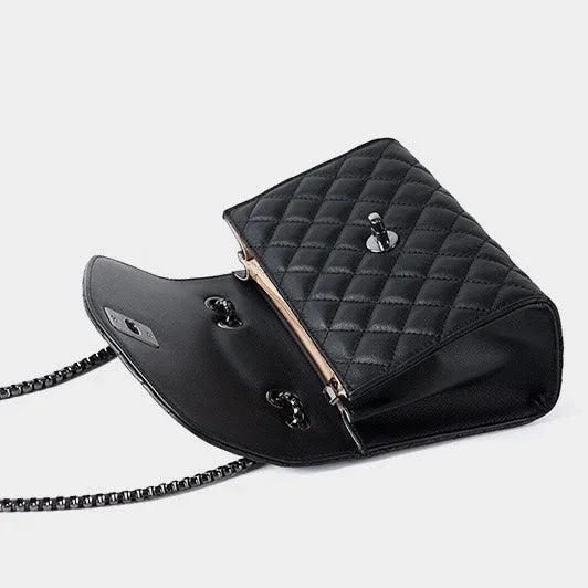 Black quilted leather shoulder bag with chain strap, open on white background