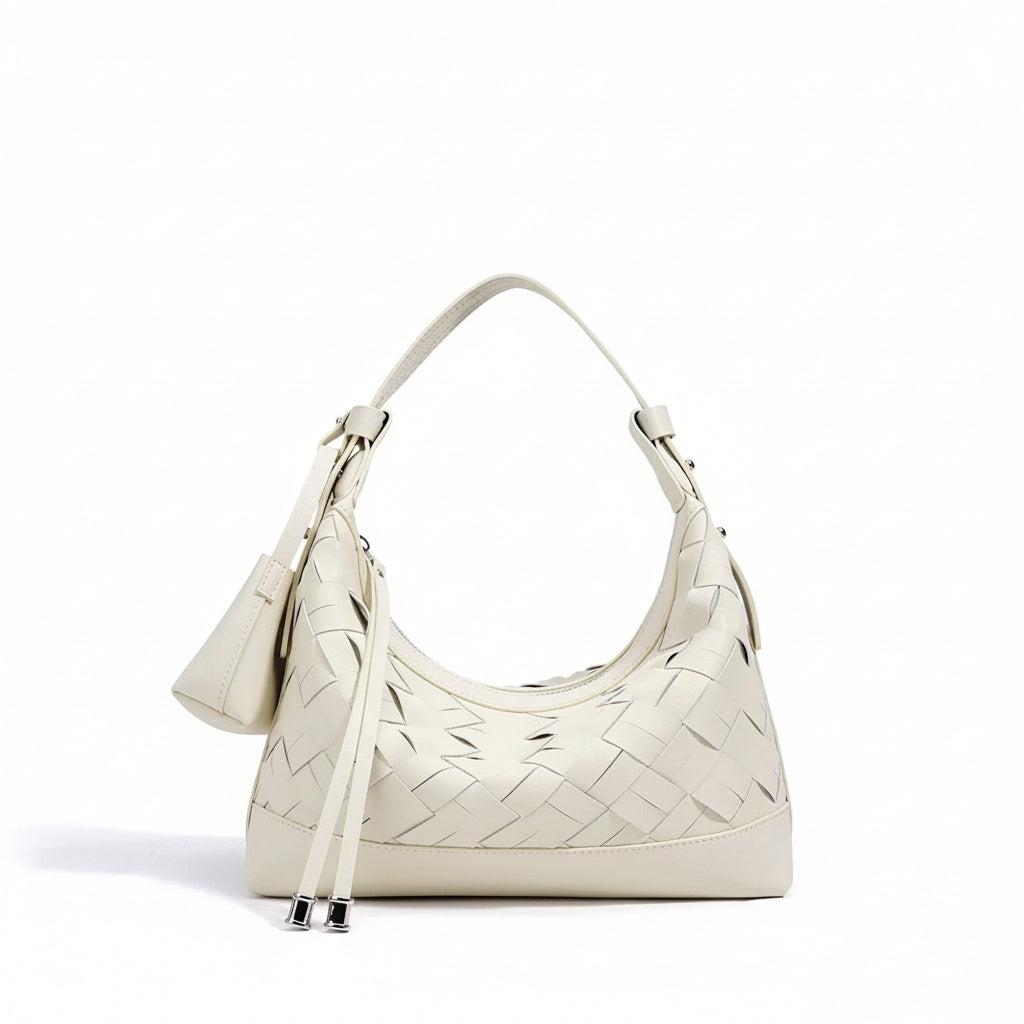 Cream woven leather shoulder bag with top handle and minimalist design on white background