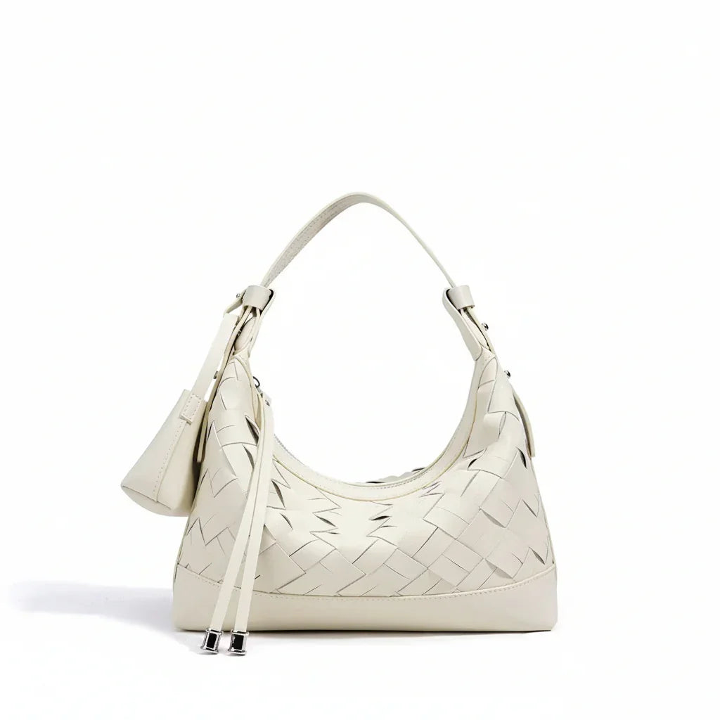 Cream woven leather shoulder bag with top handle and minimalist design on white background
