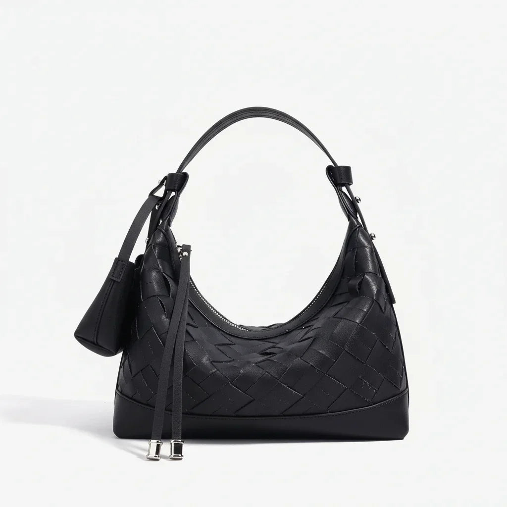 Black woven leather shoulder bag with curved handle and silver accents on white background