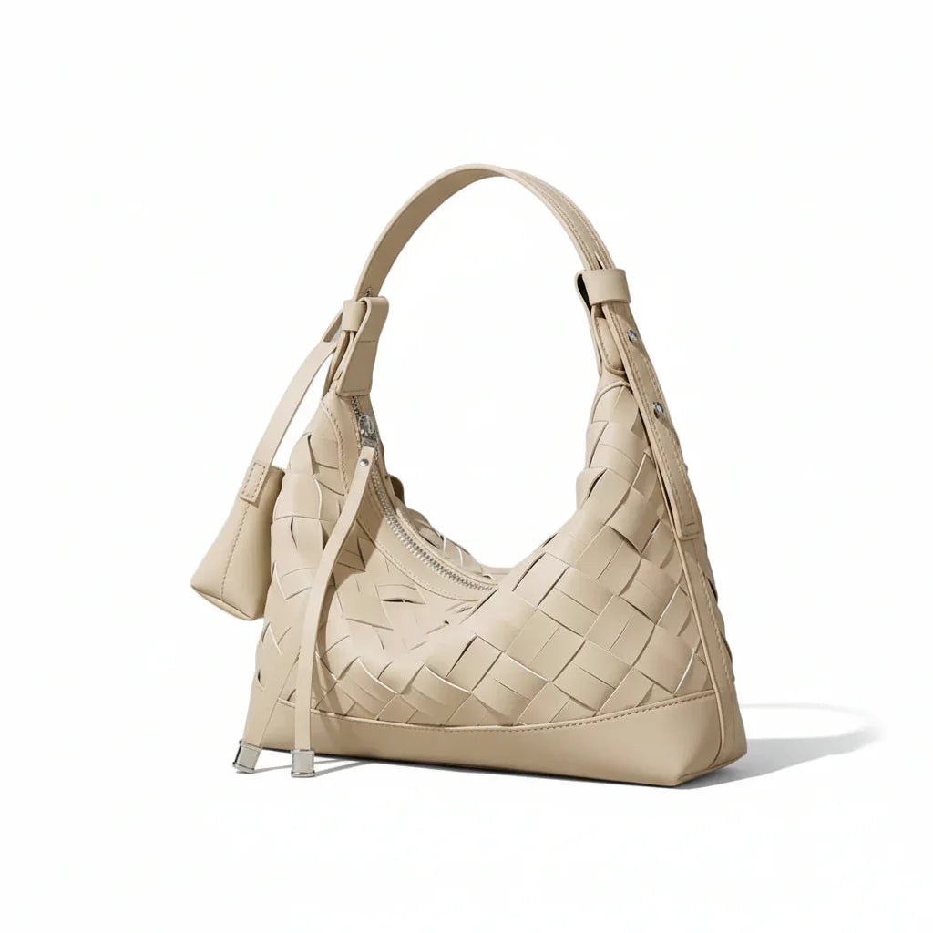 Beige woven leather hobo bag with top handle on a neutral background