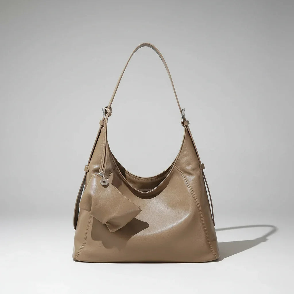 Taupe leather hobo handbag with matching pouch, minimalist background, soft shadow