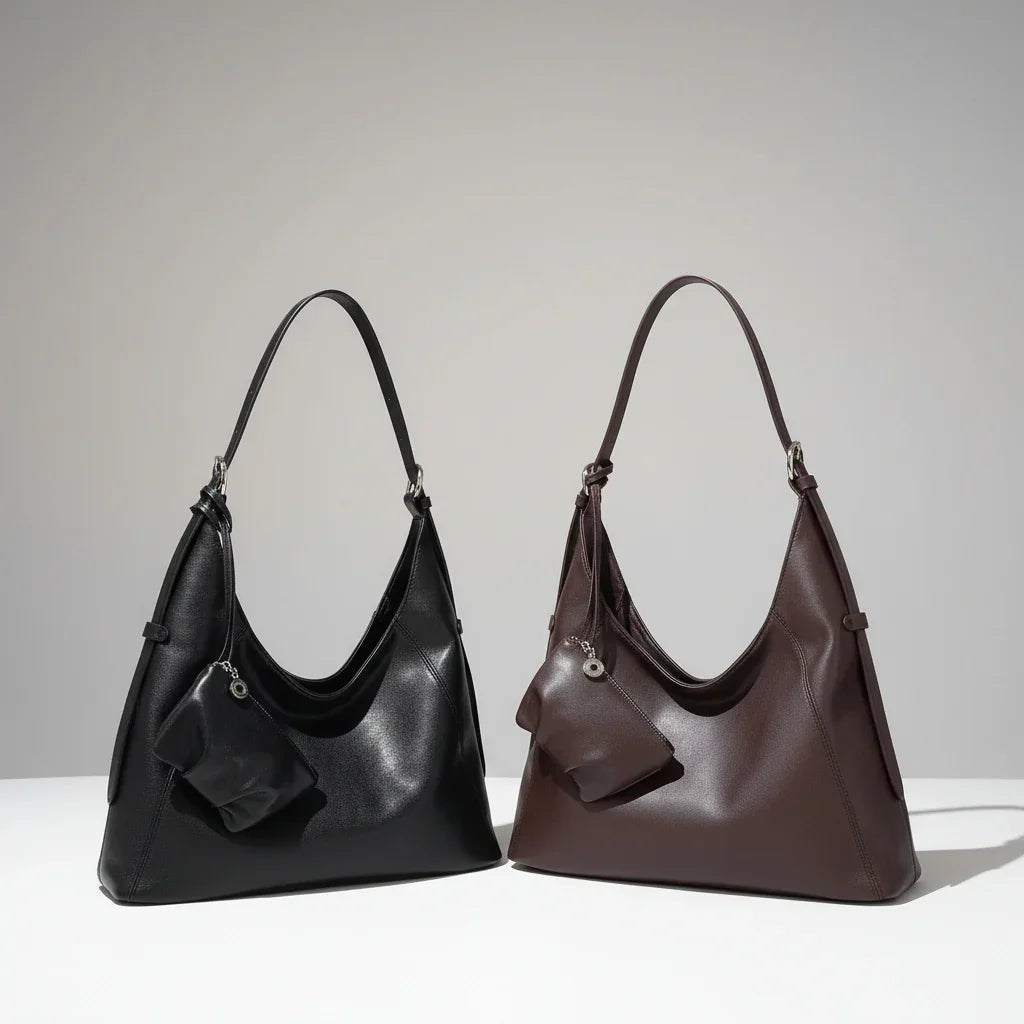 Black and brown leather hobo handbags with matching pouches on neutral background