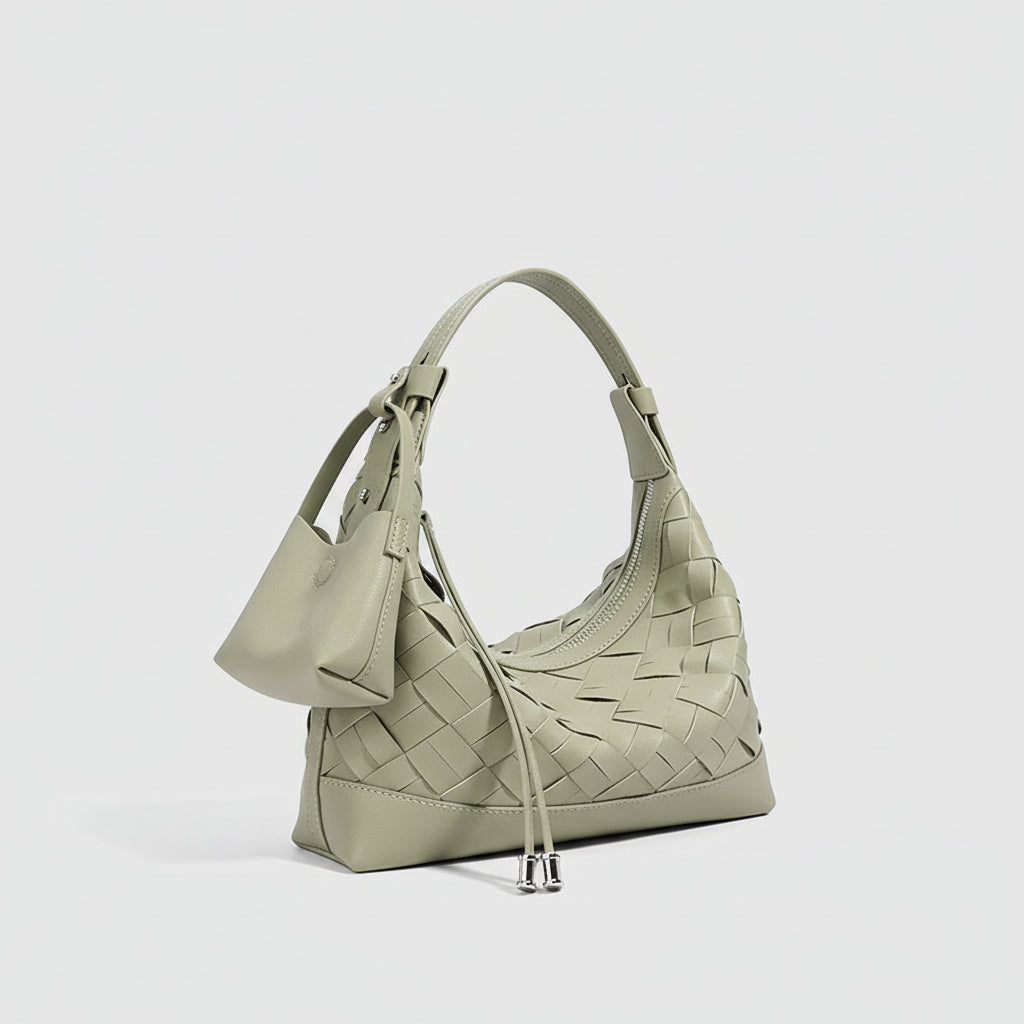 Sage green woven leather shoulder bag with small attached pouch, minimalist design