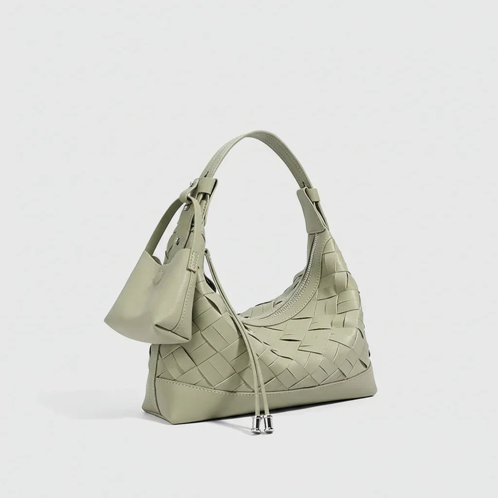Sage green woven leather shoulder bag with small attached pouch, minimalist design