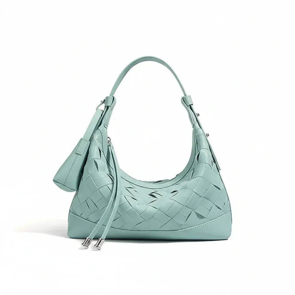 Mint green woven leather shoulder bag with zipper and matching pouch on white background