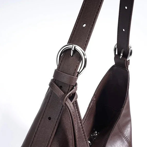 Brown leather shoulder bag with silver buckle detail on strap