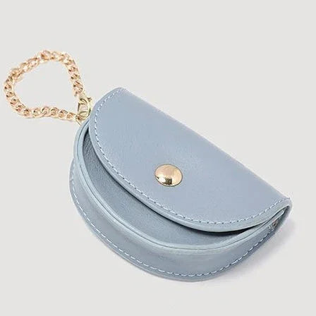 Light blue leather coin purse with gold button and chain on white background