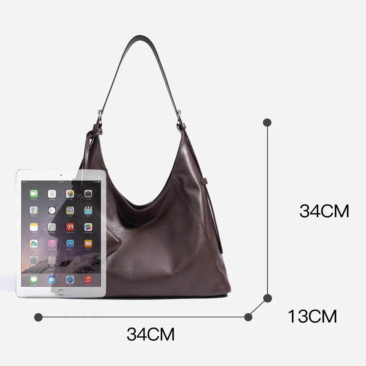 Brown leather shoulder bag with size dimensions and a tablet for scale