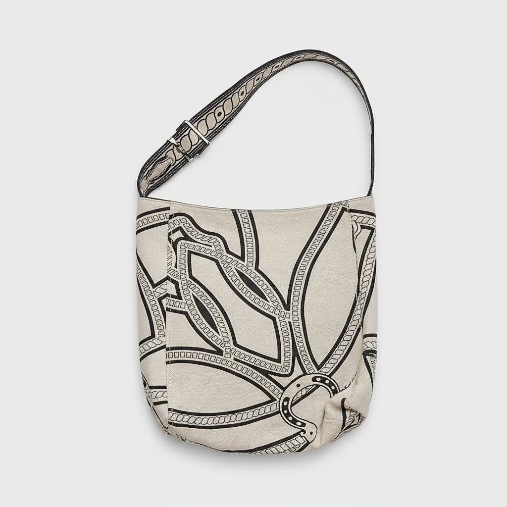 Woman wearing sleeveless beige buttoned dress with large patterned canvas crossbody bag