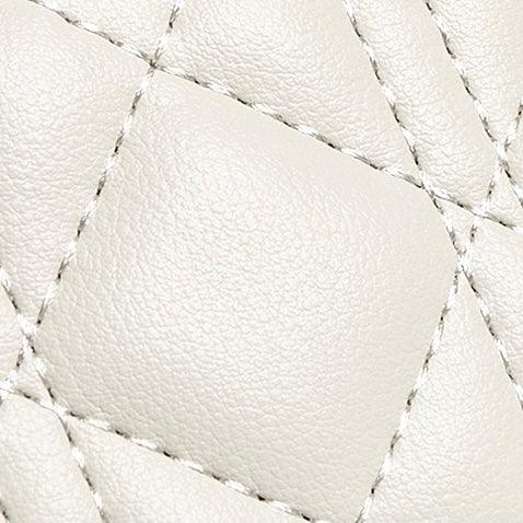 Close-up of white quilted leather texture with visible stitching detail