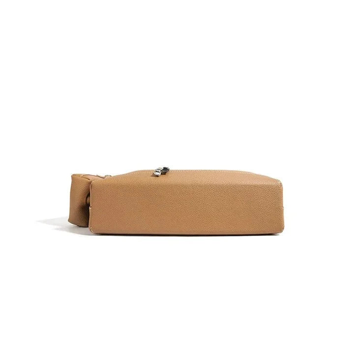 Tan leather handbag bottom view with zipper, minimalist background