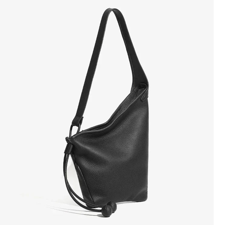 Black leather shoulder bag with drawstring closure and minimalist design on white background