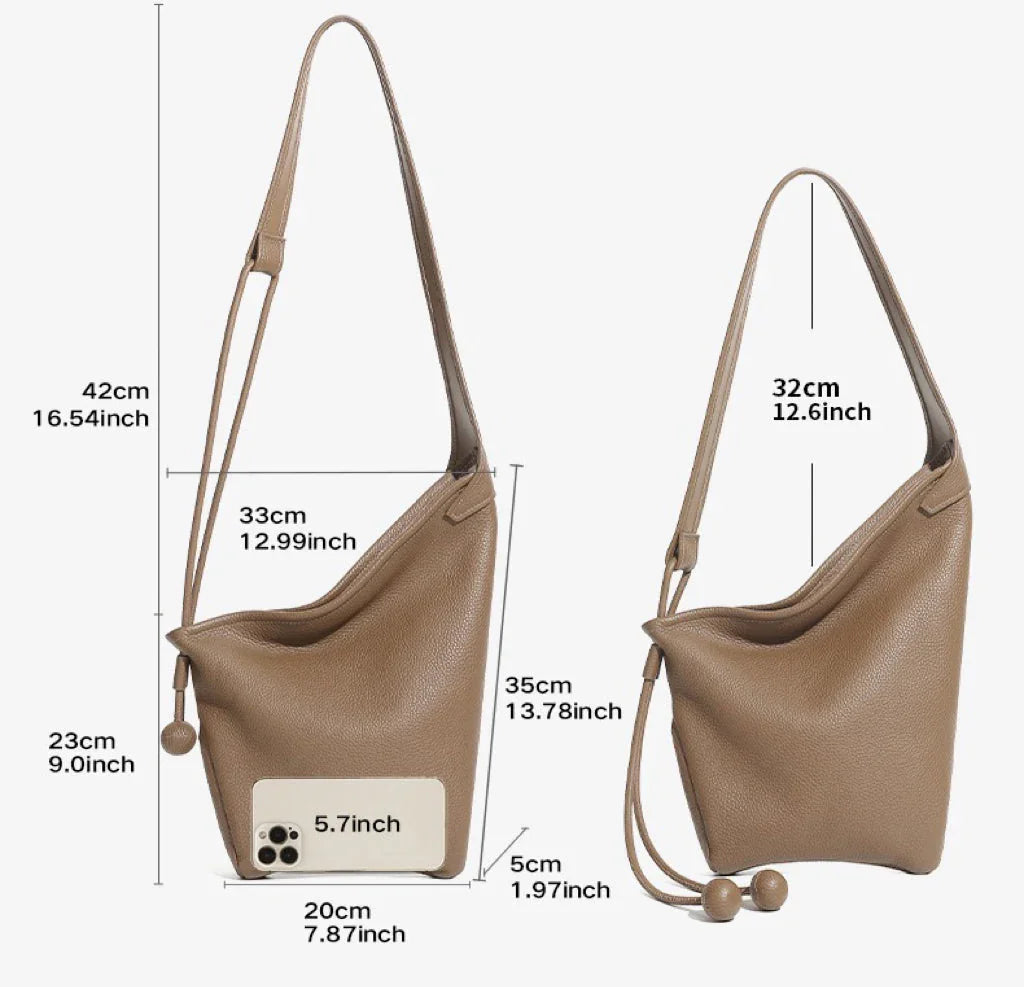 Two brown leather shoulder bags with size measurements and a phone for scale on white background.