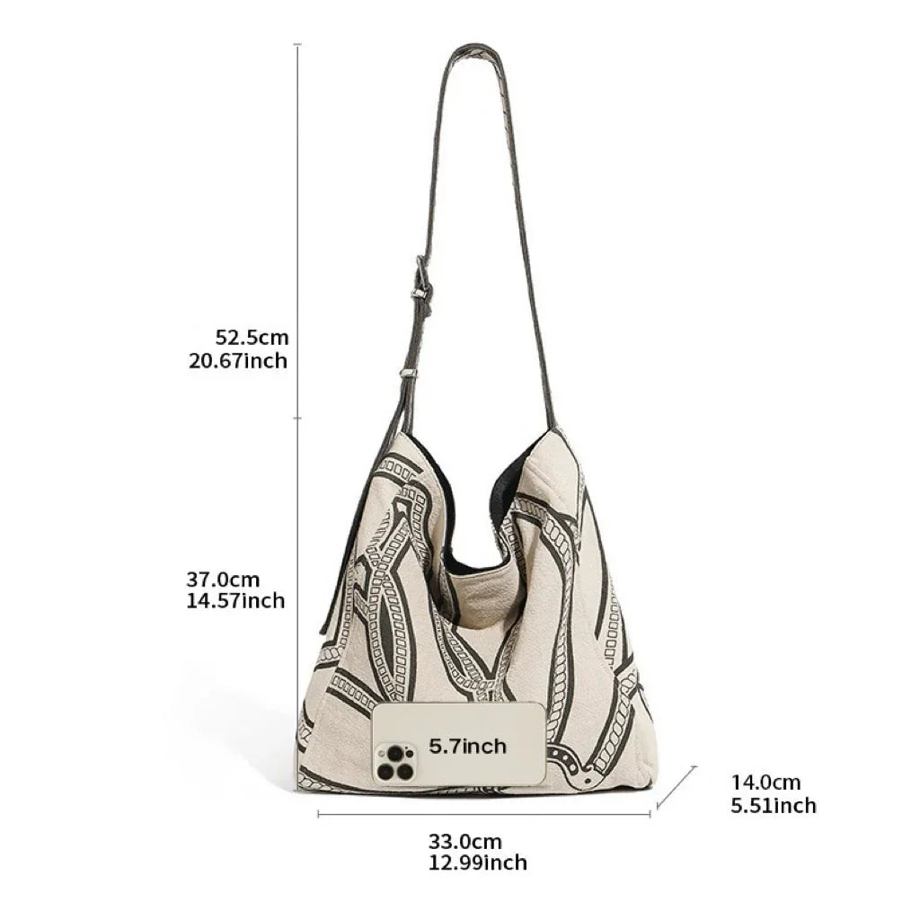 Boho patterned shoulder bag with measurements and phone for size reference