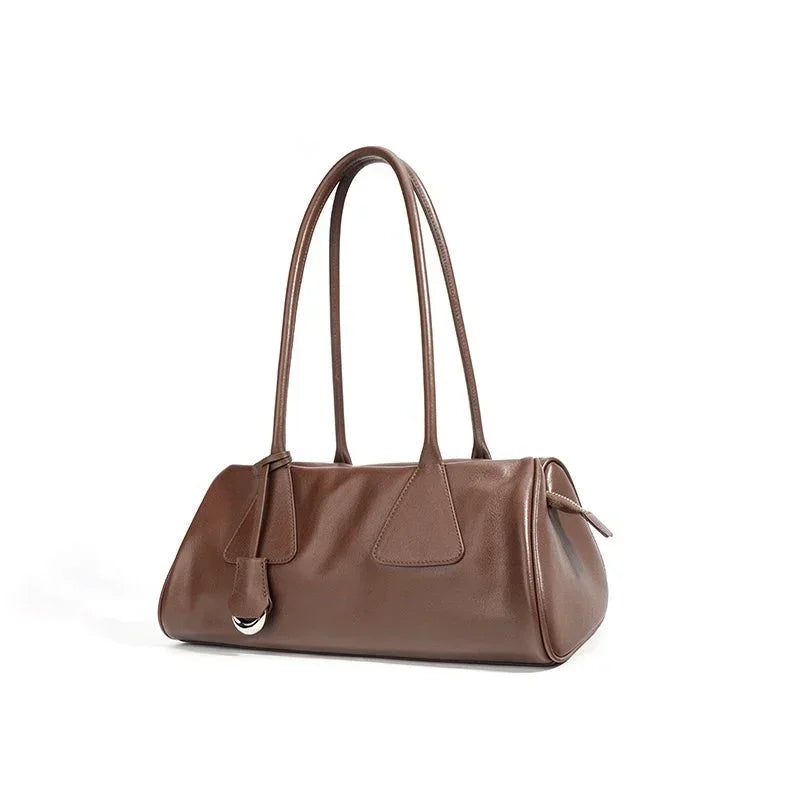 Brown leather shoulder bag with double handles on white background
