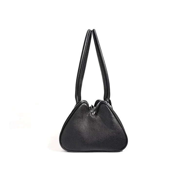 Black leather handbag with double handles and modern triangular shape on white background.